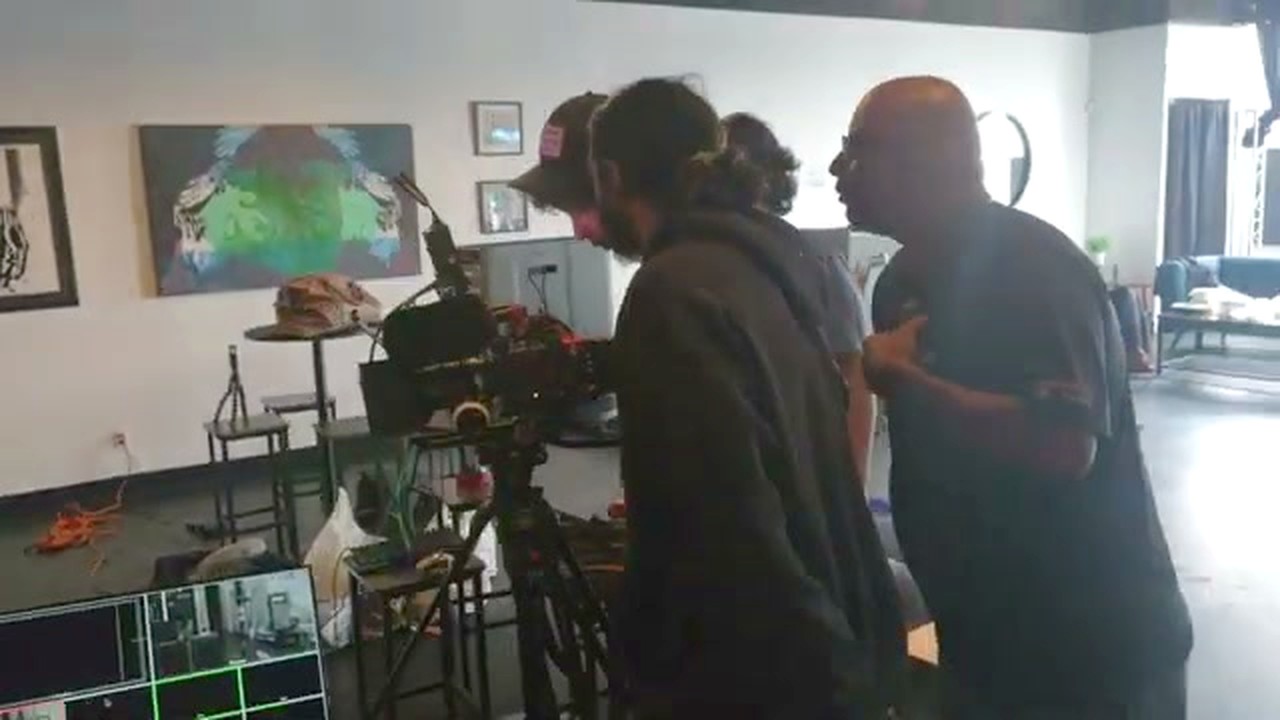 An instructor talking a crew through a camera setup on location